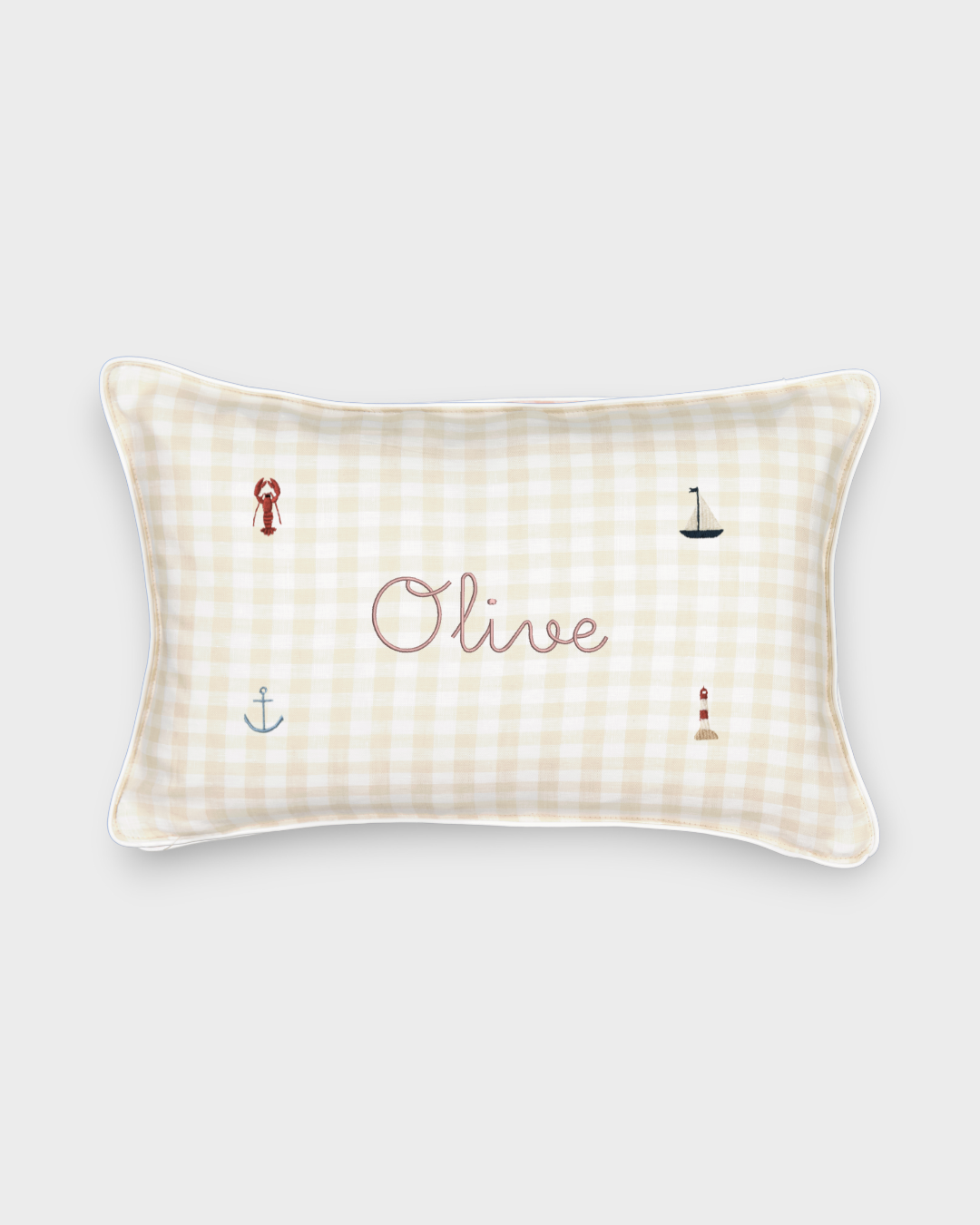 Nautical cushion with duck egg blue gingham linen, embroidered sea-themed designs, and personalized name "Olive"