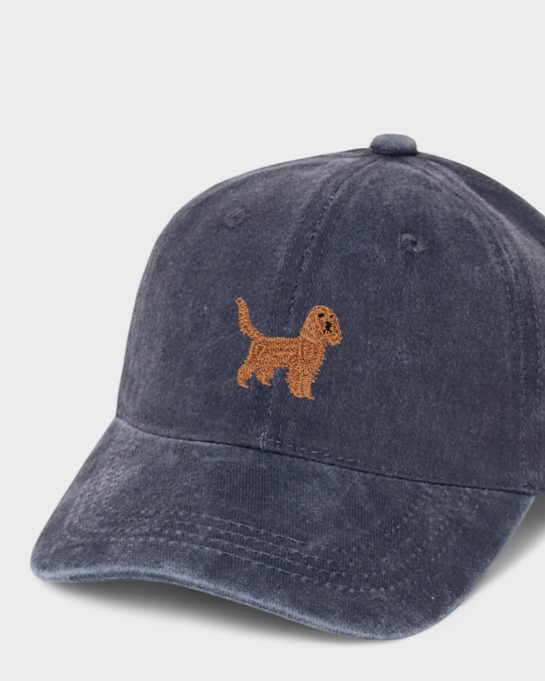 Navy blue baseball hat with embroidered Cocker Spaniel design on front and personalized embroidery on back