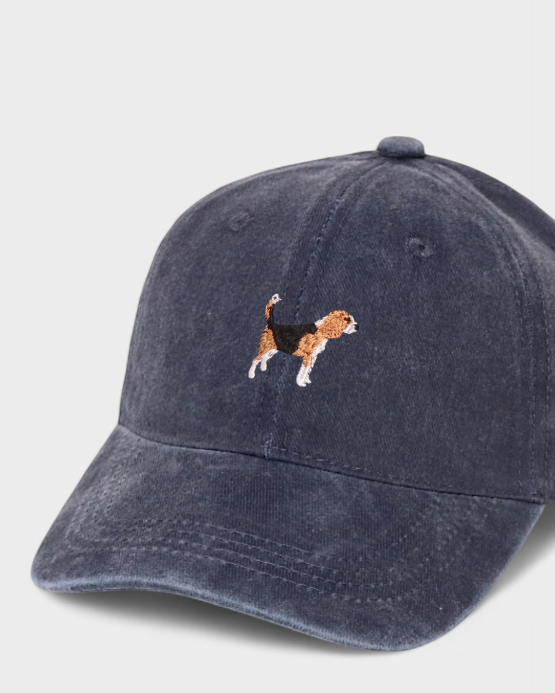 Navy blue Beagle Personalised Hat with embroidered hand-drawn Beagle design on front and customizable embroidery on back, made of 100% washed cotton.