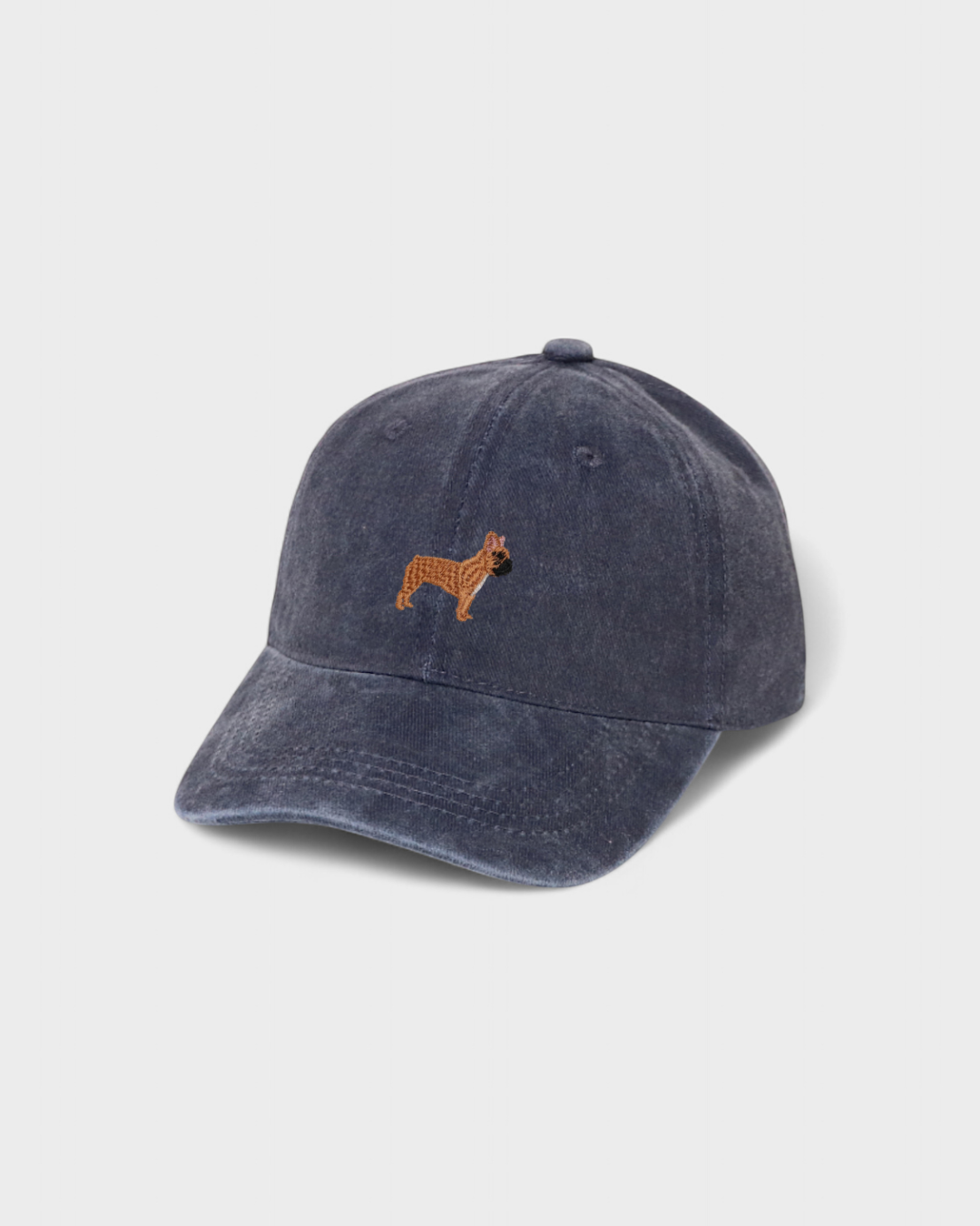 Navy blue baseball cap with embroidered hand-drawn French Bulldog design and personalized back embroidery, made of 100% washed cotton.