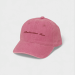 Pink personalised hat with custom embroidered text on the front, made of 100% washed cotton.