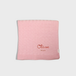Pink merino baby blanket with rosette cross stitch embroidery and personalized name Olive