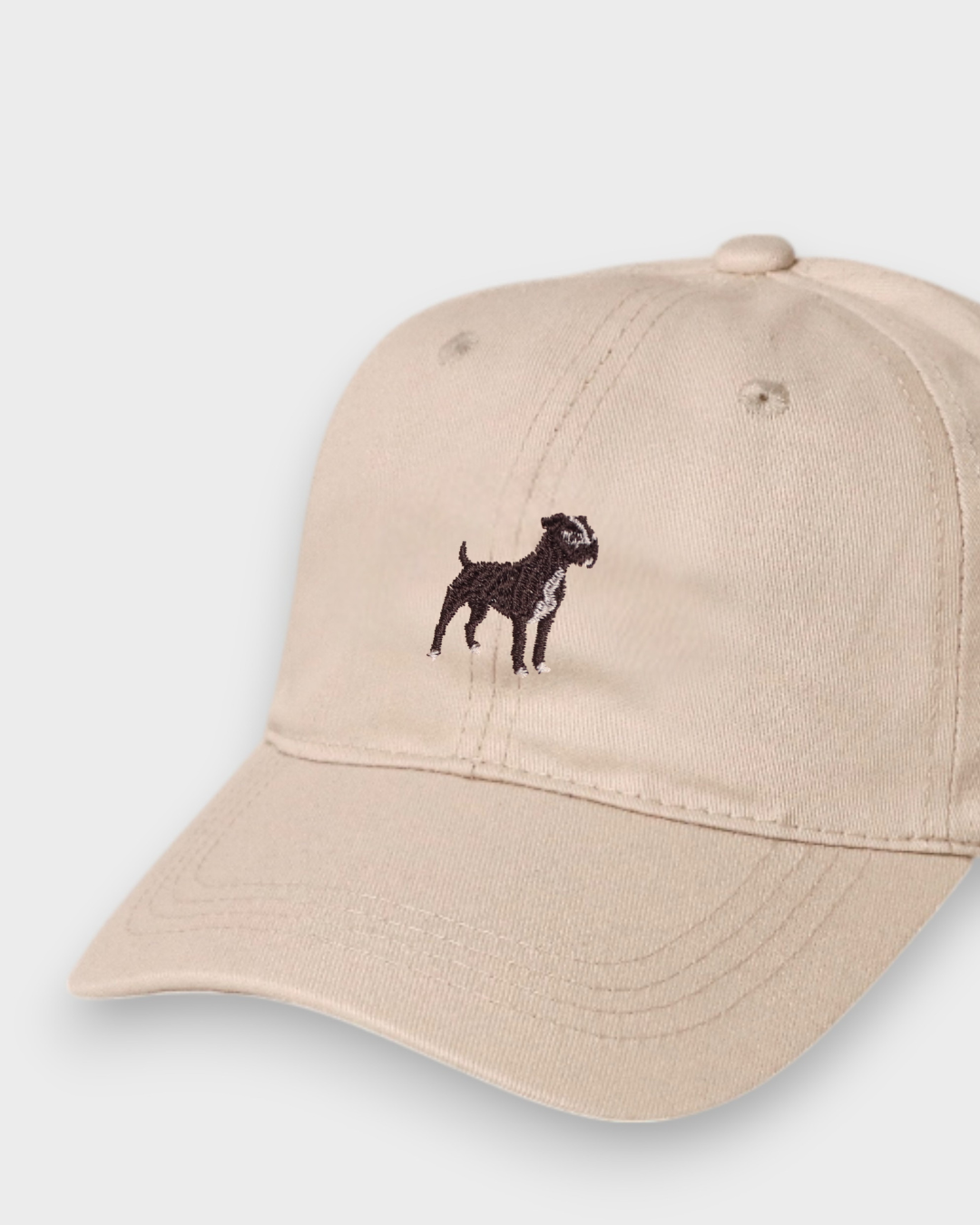 Beige baseball hat with embroidered Staffordshire Bull Terrier design on the front, made of 100% washed cotton.