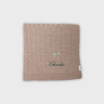 Merino baby blanket with embroidered hot air balloons and personalized name Charlie in soft wool fibers