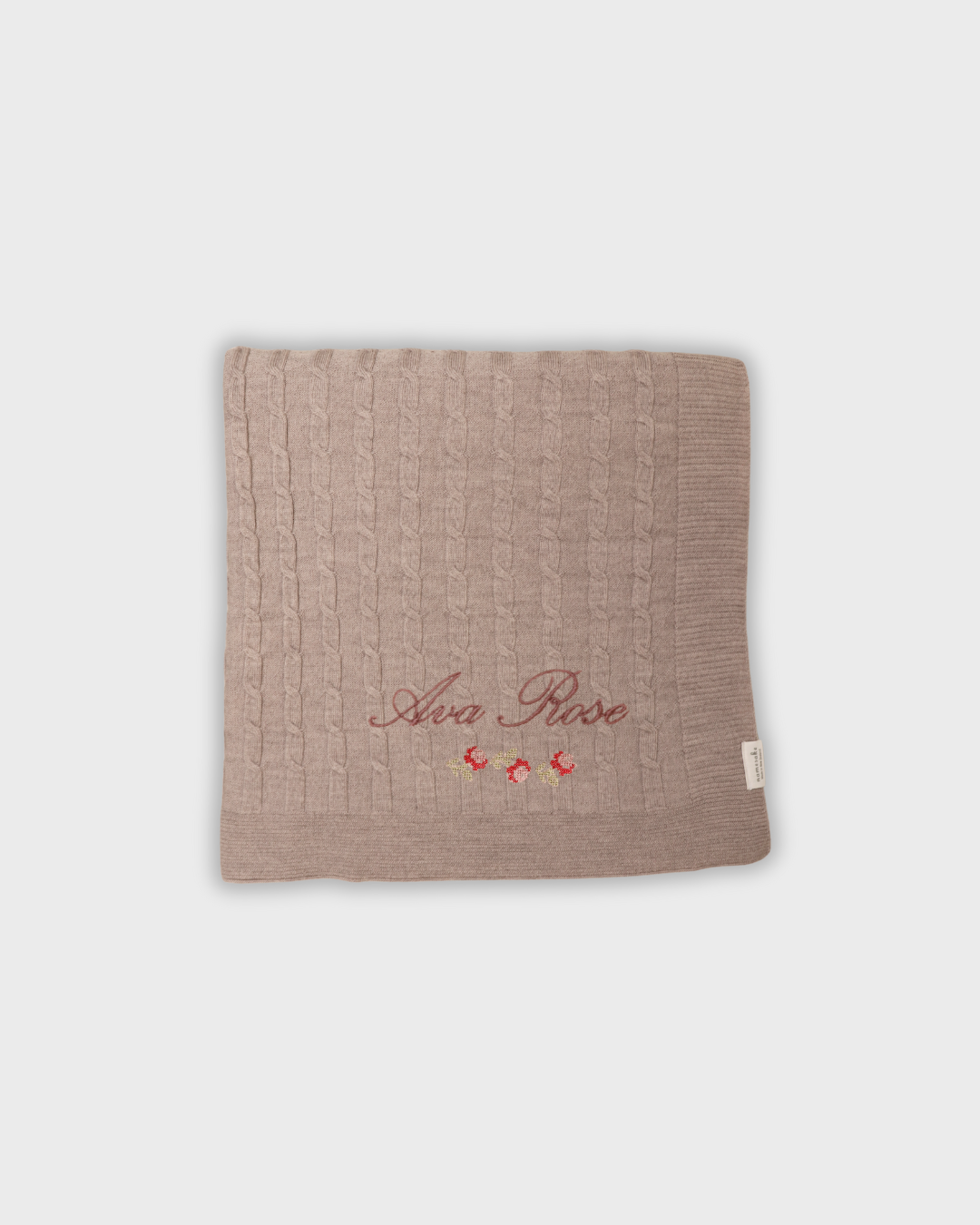 Soft Merino baby blanket with personalized rosette embroidery and cable knit design