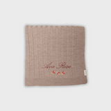 Soft Merino baby blanket with personalized rosette embroidery and cable knit design